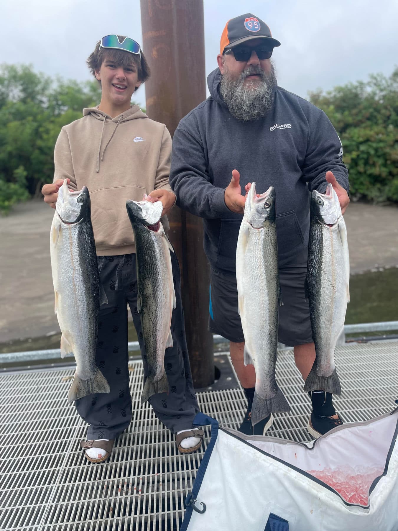Two anglers with their limit of salmon at the dock